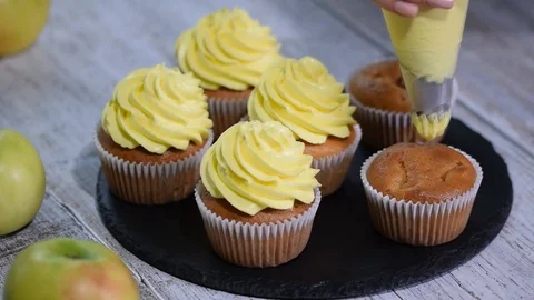 Decoration cupcake with yellow icing. Making multicolor cupcakes for kids Stock Footage 98779510