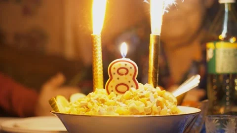 Decoration of the dish in the form of a candle with the number eight and burning Stock-Footage 149002553