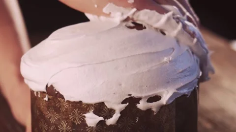 Decoration of the Easter cake with icing sugar on the dark wooden background Video stock 156361618