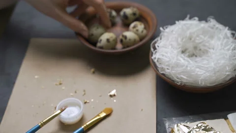 Decoration of Easter eggs with gold foil Stock Footage 101688389