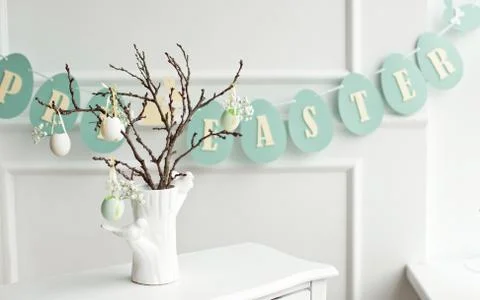 Decoration of the Easter table, a vase with a branch and decorations from Stock Photos