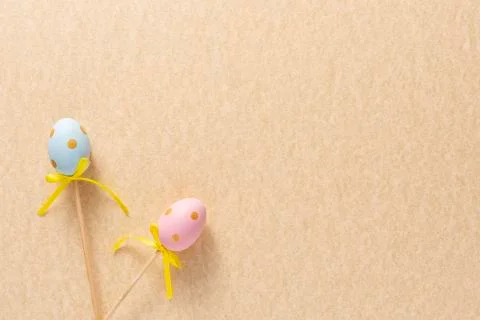 Decoration in the form of Easter eggs on a mustard background. Copy space Eas Stock Photos