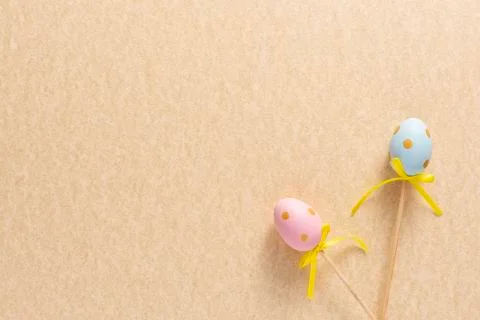 Decoration in the form of Easter eggs on a mustard background. Copy space Eas Stock Photos