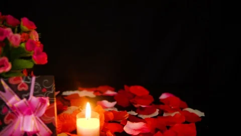 Decoration Valentine day with gift boxes, candle burning and rose petals footage 스톡 동영상 101222519