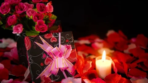 Decoration Valentine day with gift boxes, candle burning and rose petals footage Video stock 101222568