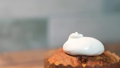 Decoration of white easter cake glaze, close-up in the kitchen, at home 動画素材 128828832