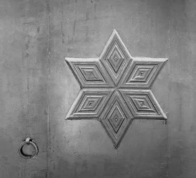 Decorations based on octagon star of David engraved on wooden door with door Stock Photos
