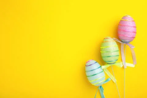 Decorativ eggs on yellow background. Easter concept. Stock Photos