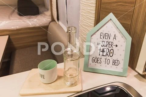 Decorativ sign, even a super hero goes to bed, is written on it Stock Photos