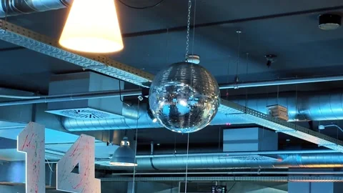 Decorative and Sparkling Disco Balls Gracefully Hanging in a Modern Stock Footage 336448009