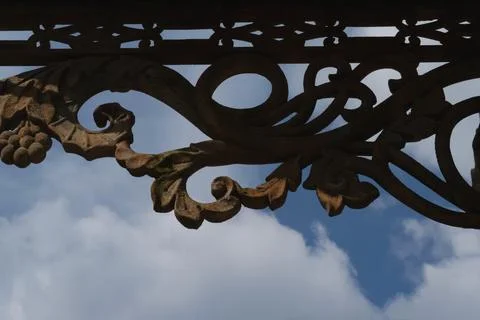Decorative architectural elements. Antique cast metal brackets. Close-up. Bra Stock Photos