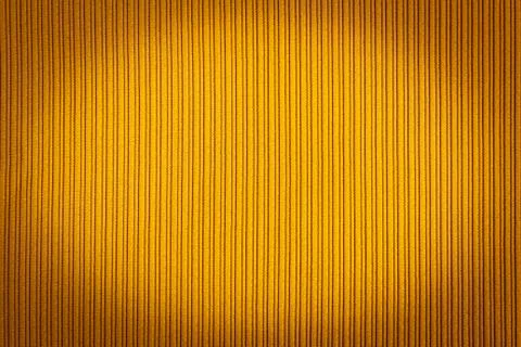 Decorative background yellow color, striped texture vignetting gradient. Wall Stock Photos