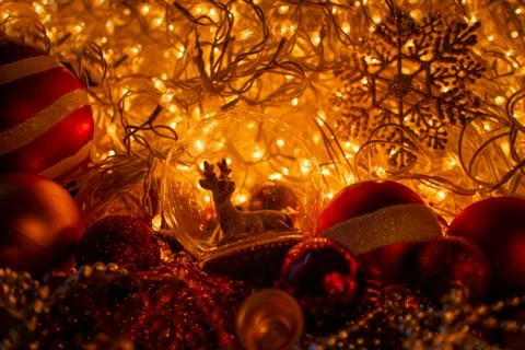 Decorative ball with a deer inside, close-up with blurred Christmas lights. Toys Stock Photos
