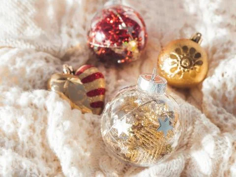 Decorative balls for Christmas tree on cable-knit sweater. Transparent sphere Stock Photos