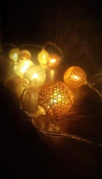 Decorative balls of yarn, balls of thread, Christmas decoration, fairy lights Stock Photos