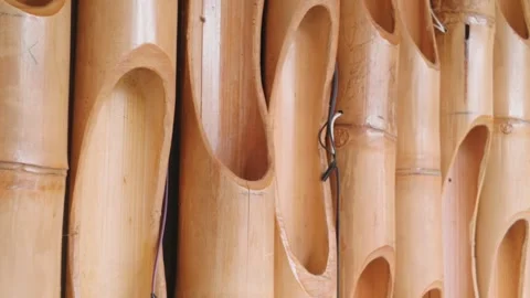 Decorative bamboo wall paneling with hollow cut sections for interior design. 库存影片 343406928