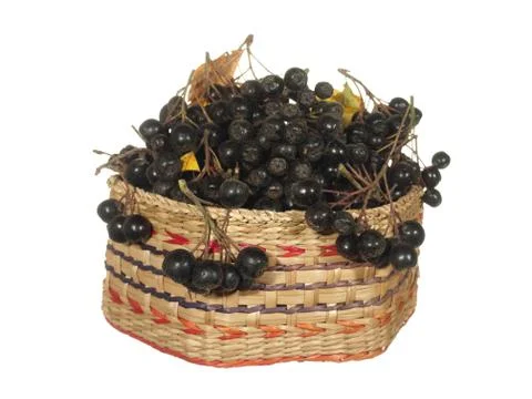 Decorative basket of hexagonal shape with black berries isolated on white bac Stock Photos