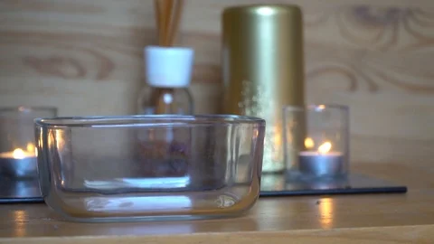 Decorative blue pebble slow motion fall down into the glass plate Stock Footage 92092014