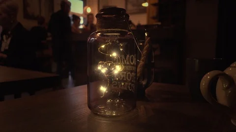 Decorative bottle with lights on table Stock Footage 108522023
