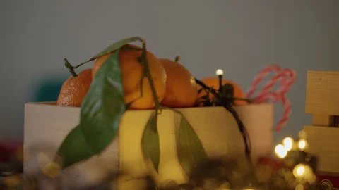 Decorative box featuring tangerines enhanced by soft warm light glow. Cheerful Stock Footage 333301661