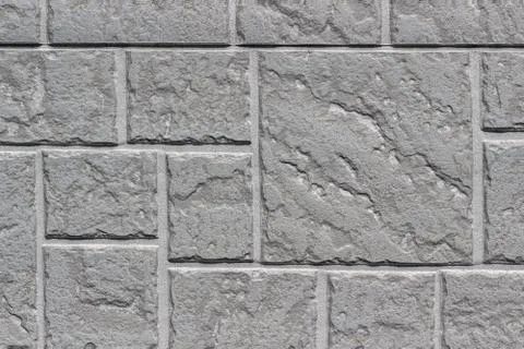 Decorative brick gray wall close up as a background or texture. Stock Photos