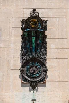 Decorative bronze wall clock with Roman numerals Stock Photos