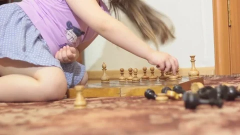 DECORATIVE BROWN RABBIT SNIFFING THE CHESS PIECES Stock Footage 74884028