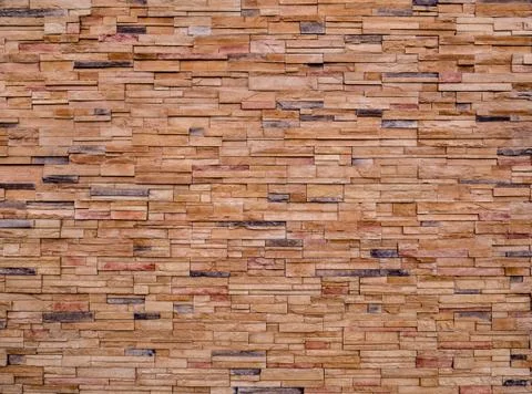 Decorative brown stone setting. Cut stone wall texture. Stock Photos