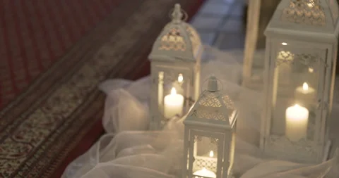 Decorative candles and lanterns on draped fabric Video stock 336469530