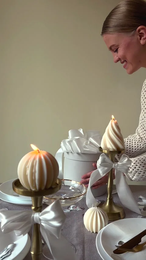 Decorative candles illuminate table setting with soft glow Stock Footage 341852027