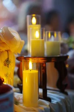 Decorative candles on a table create a warm atmosphere Stock Photos
