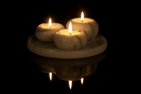 Decorative candlestick of marble with three lights at a black background Stock Photos