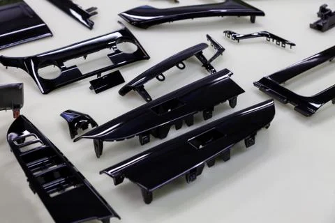 Decorative car interior trim elements repaired and painted in black glossy co Stock Photos