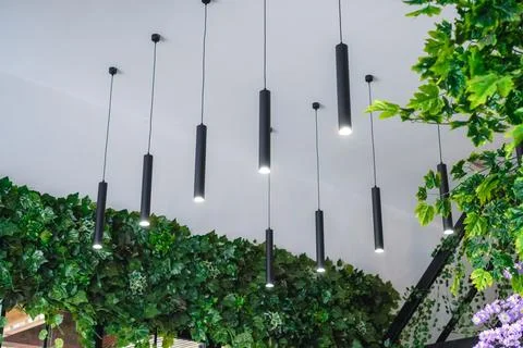 Decorative ceiling lights or hanging lights in the form of black tubes Stock Photos