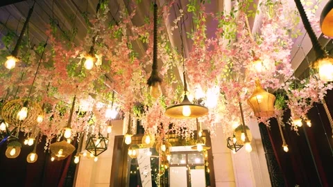 Decorative Ceiling with Pink Blossoms and Edison Lights Stock Footage 342097685
