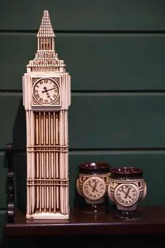 Decorative ceramic clock tower and cups in the interior of pub Stock Photos