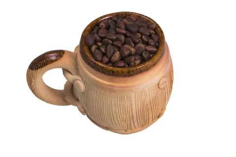 Decorative ceramic mug with pine nuts. Stock Photos