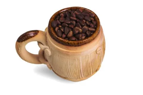 Decorative ceramic mug with pine nuts. Stock Photos