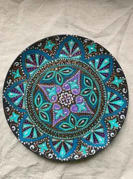 Decorative ceramic plate with  different colors. painted plate on white backg Stock Photos