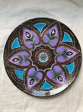 Decorative ceramic plate with  different colors. painted plate on white backg Stock Photos