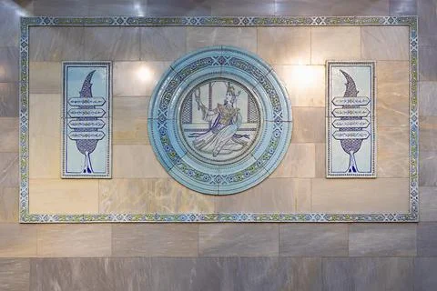 Decorative ceramic tile panel with a seated figure medallion and ornamental.. Stock Photos
