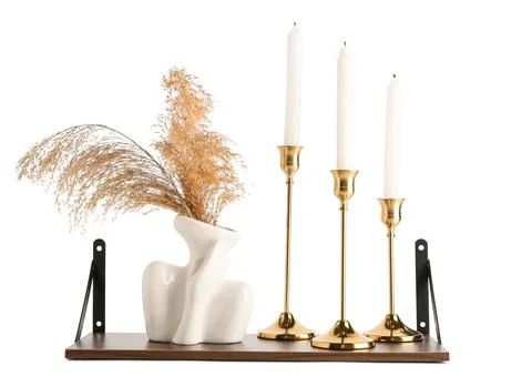 Decorative ceramic vase with dried grass and gold candle holders Stock Photos