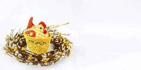 Decorative chicken in a yellow wicker basket on a white isolated background Stock Photos