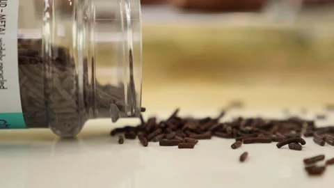 Decorative chocolate spilling from a jar Stock Footage 253609528