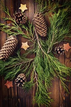 Decorative christmas composition - spruce, pine cones, stars on wooden back.. Stock Photos