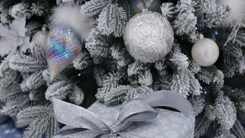 Decorative Christmas tree adorned with white flowers, silver ornaments, and Stock Footage 336400310