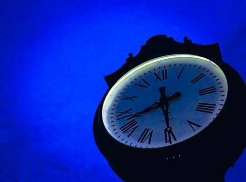 A decorative clock at night in the middle of the small town of Orwell, Ohio Stock Photos