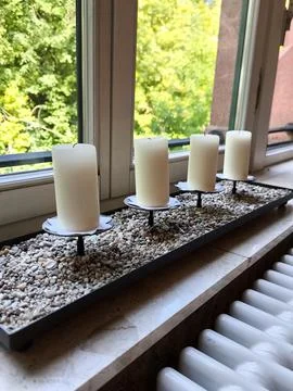 Decorative composition with candles on the windowsill Stock Photos