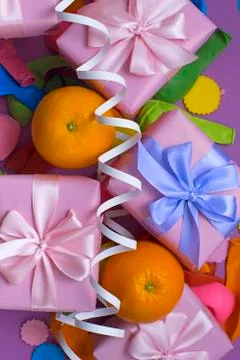 Decorative composition five boxes with gifts Satin ribbon Bow Oranges Confett Stock Photos