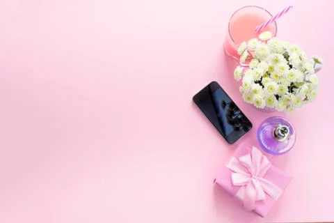 Decorative composition flat lay set of items flowers mobile perfume cocktail  Stock Photos